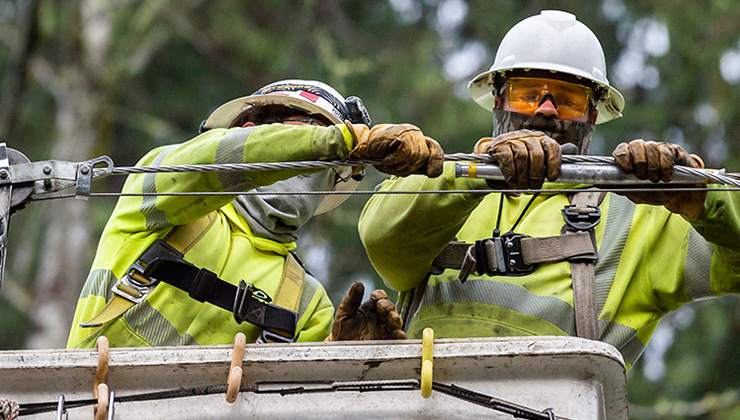 Puget Sound Energy crews repair broken power poles